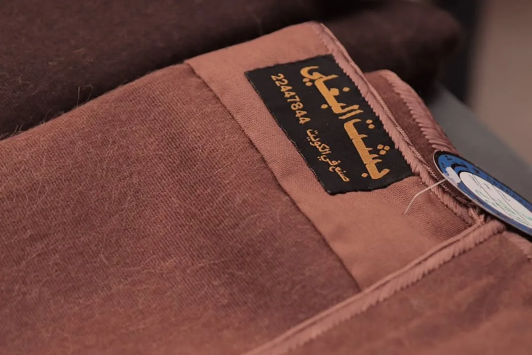 Brown wool bisht fabric with the woven Albaghli label