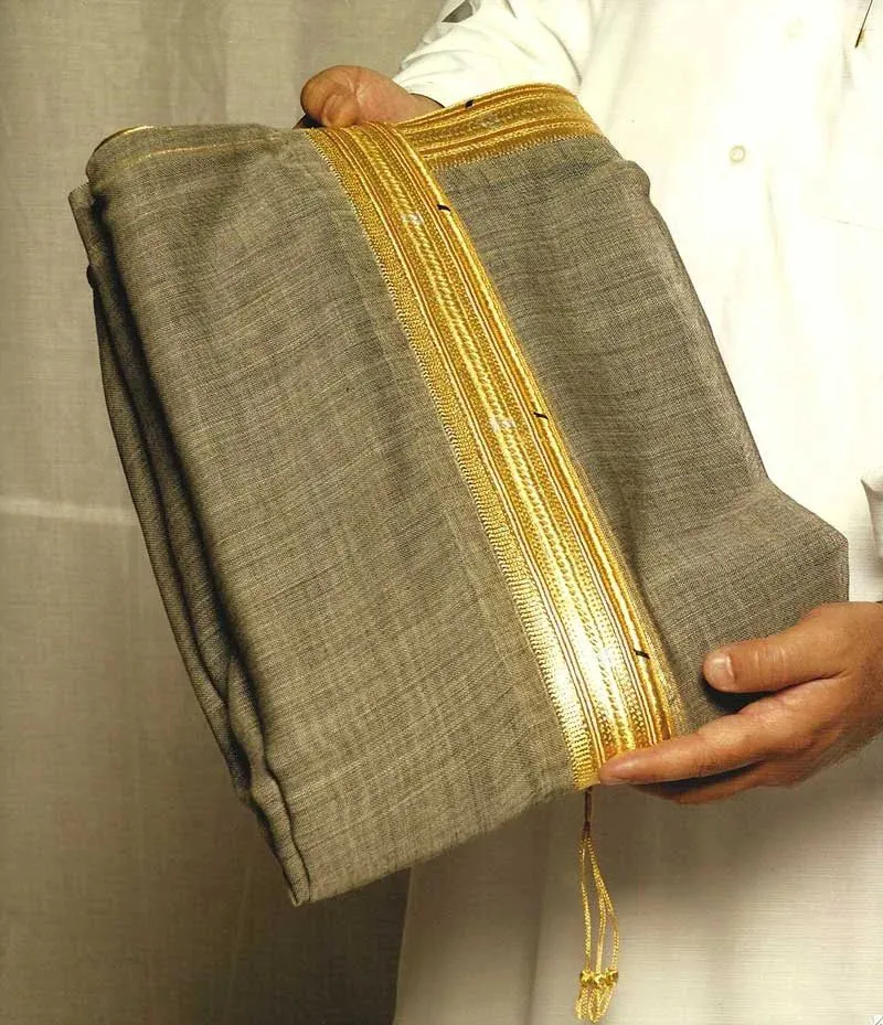 Folded grey bisht with wide gold zari held in two hands