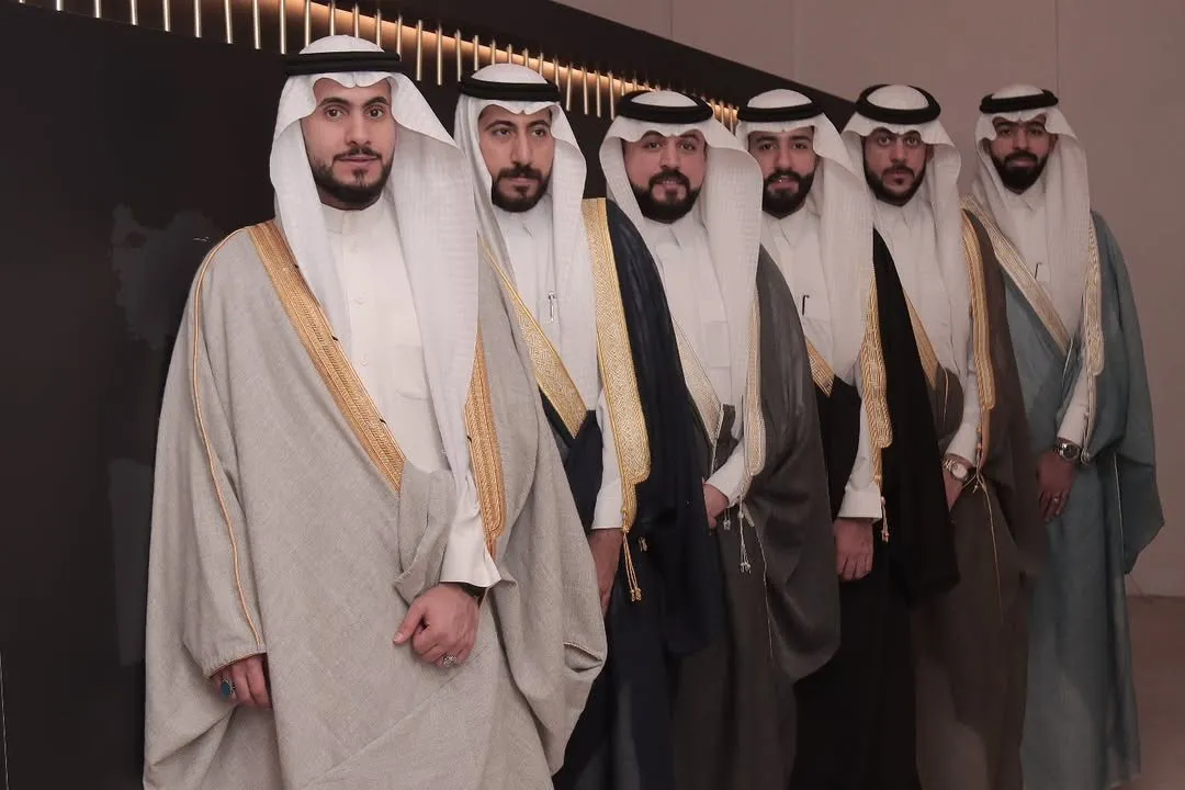 Six men in grey, black, olive and blue-grey Albaghli bishts at the Hasawi Bisht exhibition